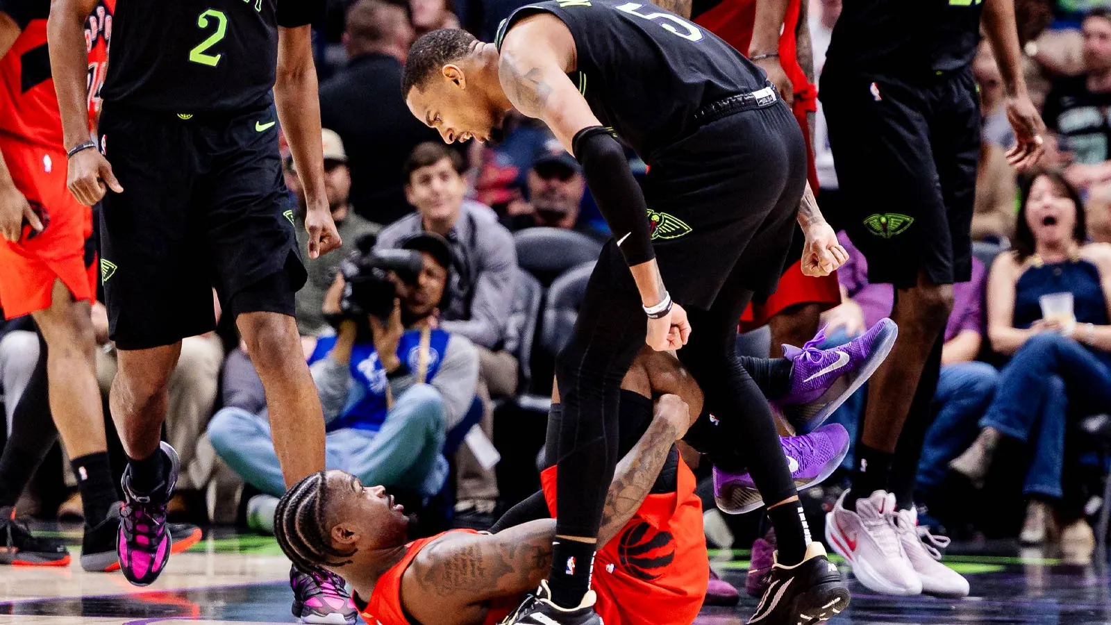 The picture of Dejounte Murray standing over Jamal Sheed is tough